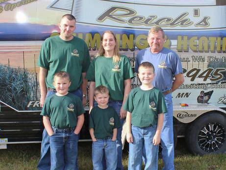 family pic Reich Family in front of Reich's Plumbing & Heating company vehicle